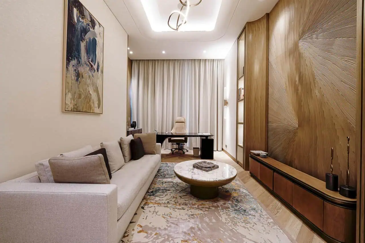 A modern living room featuring a large, colorful painting prominently displayed on the wall.