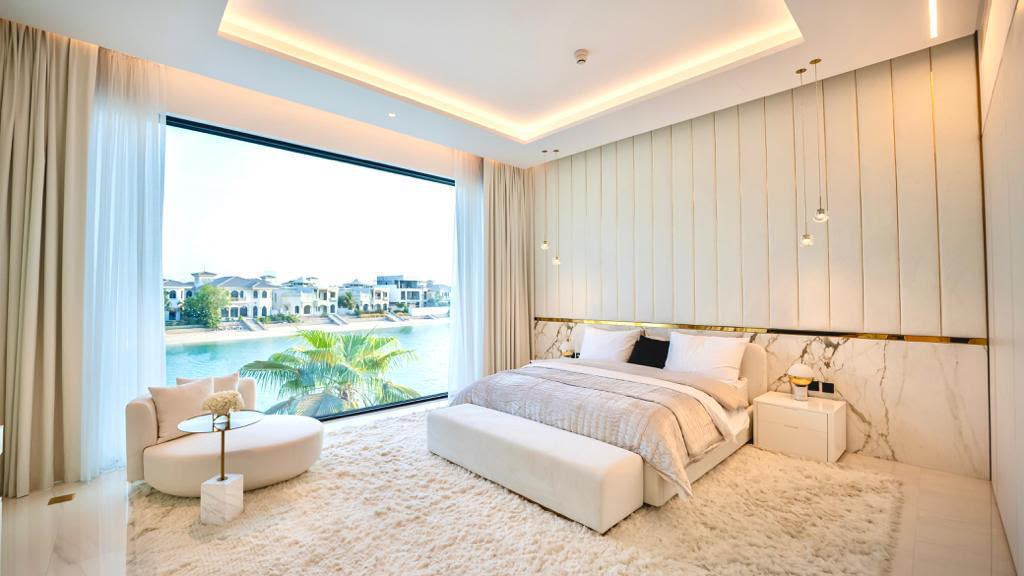 A cozy living room featuring a sleek marble wall and a modern television, creating a stylish and inviting atmosphere.