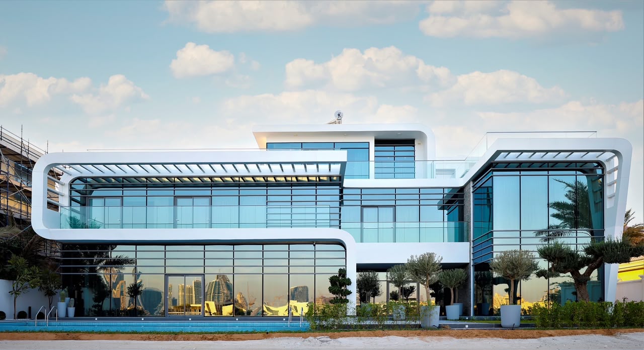  A sleek modern house with large windows and two cars parked in the driveway, showcasing contemporary design and style.