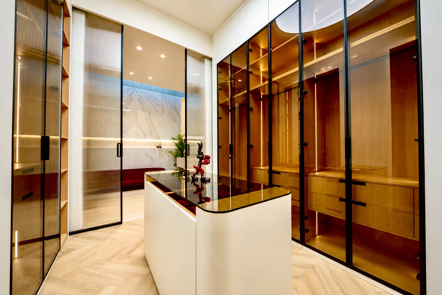 A cozy living room featuring a sleek marble wall and a modern television, creating a stylish and inviting atmosphere.